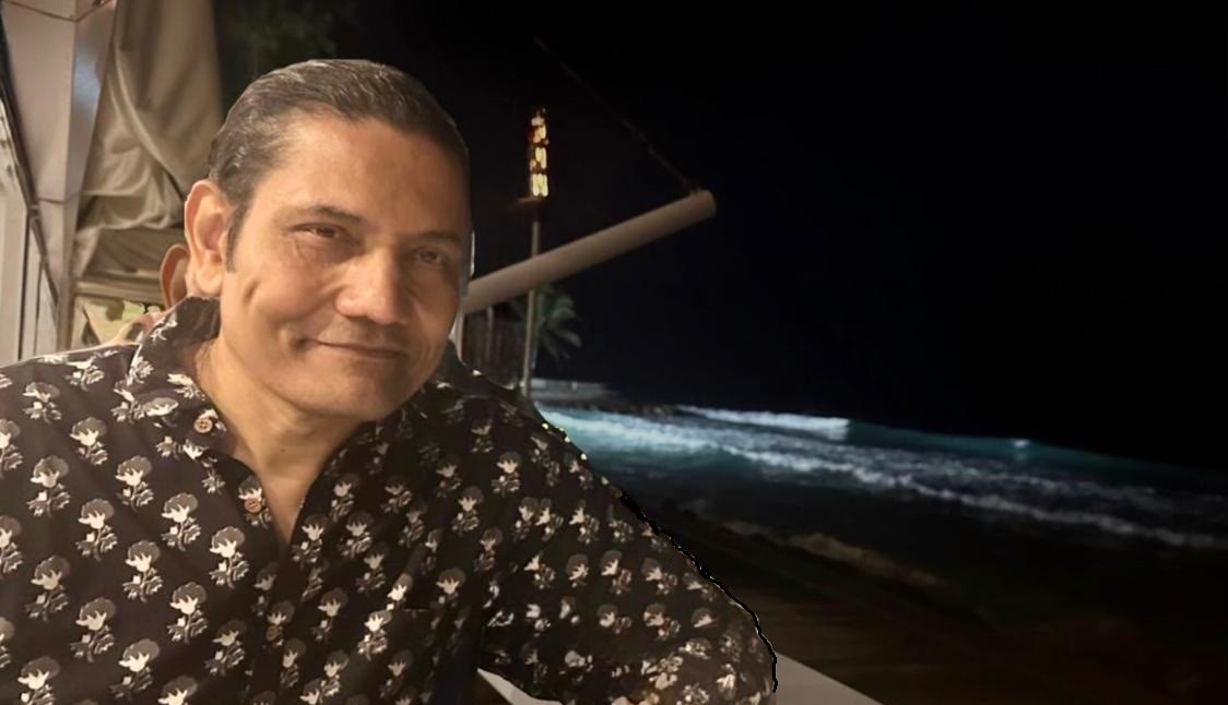 Ron Mukherjee by the sea at night, in conversation